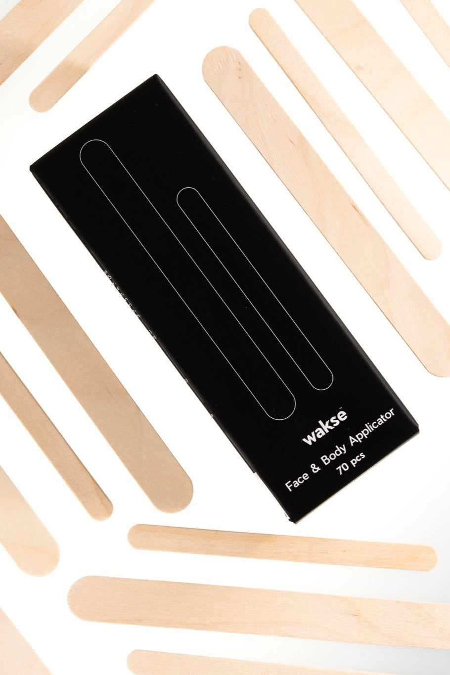 Face and body wax applicator set with multiple wooden sticks and sleek black packaging