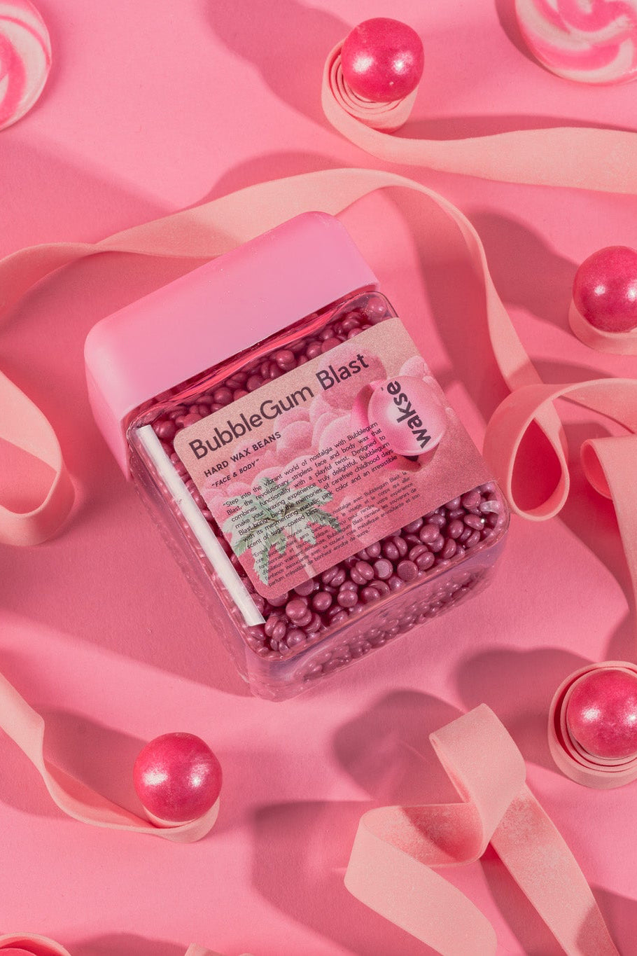 wakse Jar of bubblegum balls on a pink background with candy decorations