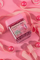 wakse Jar of bubblegum balls on a pink background with candy decorations