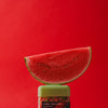 wakse Sliced watermelon on top of a container with a red background