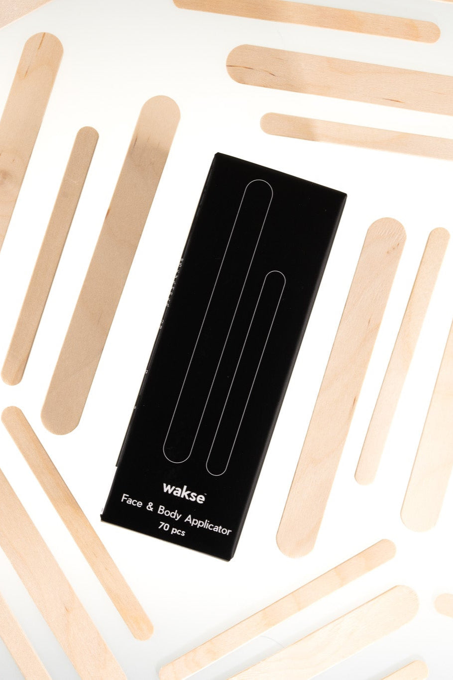 Wakse LLC face and body applicator sticks for at home waxing kit displayed with multiple wooden sticks