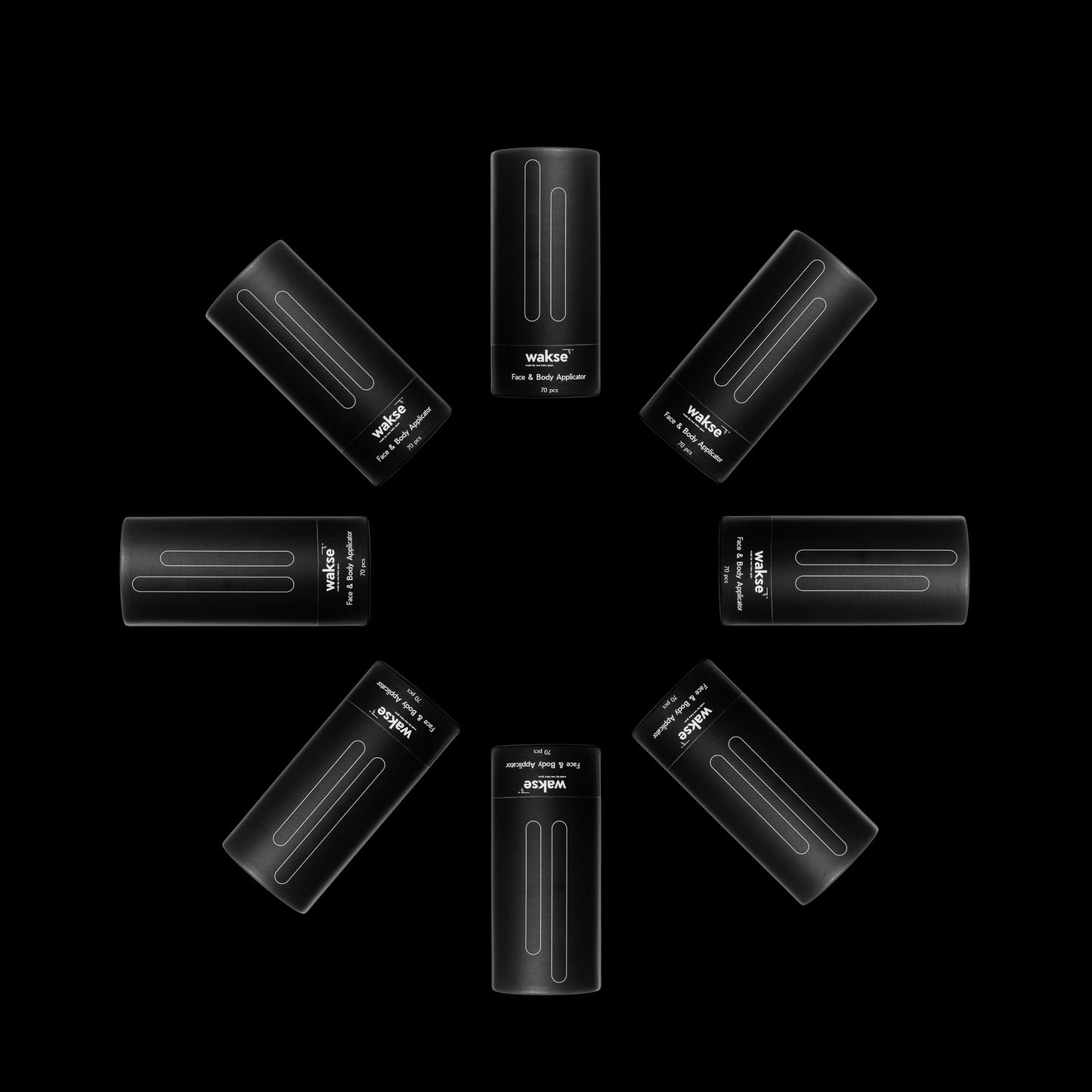 Black face and body wax applicator set arranged in a circular pattern on black background