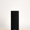 Black packaging box for face and body wax applicator set with wooden sticks around it